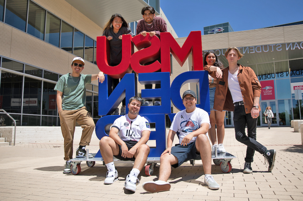 Students posing around MSU Denver sign outside JSSB